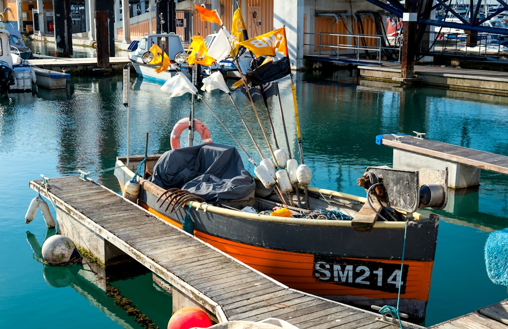 a small boat is docked at a pier