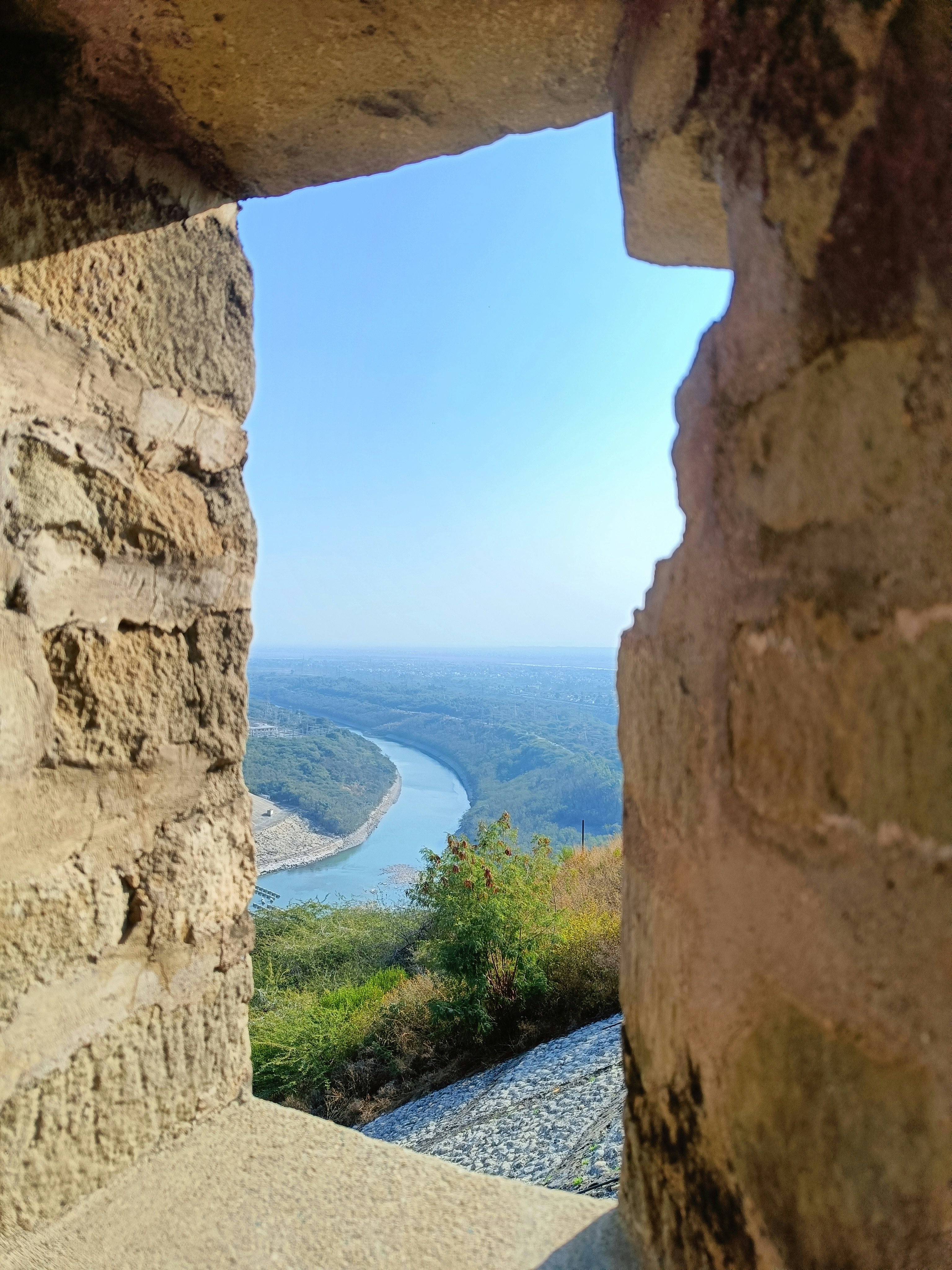 a view of a river through a stone window