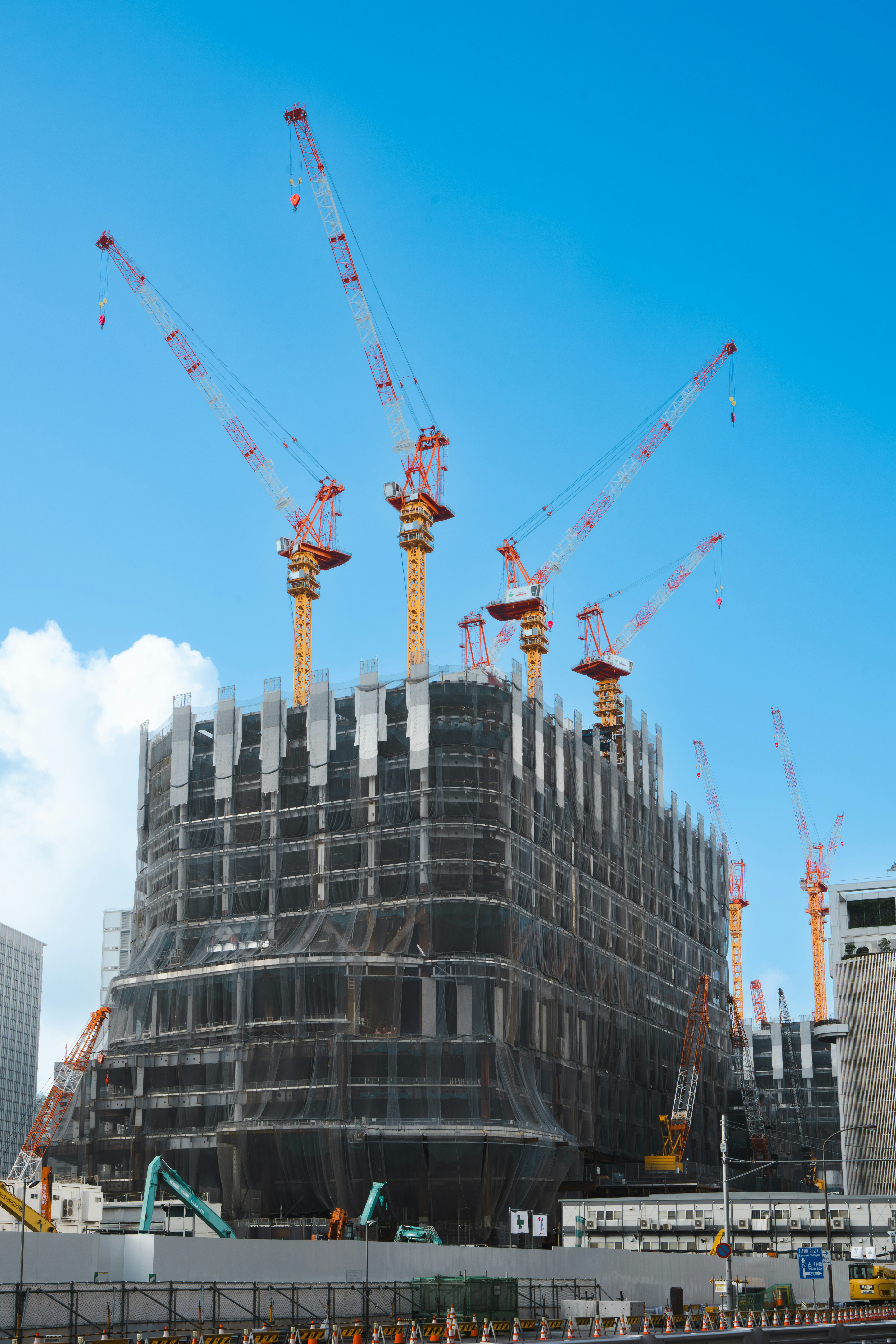 a large building under construction with lots of cranes