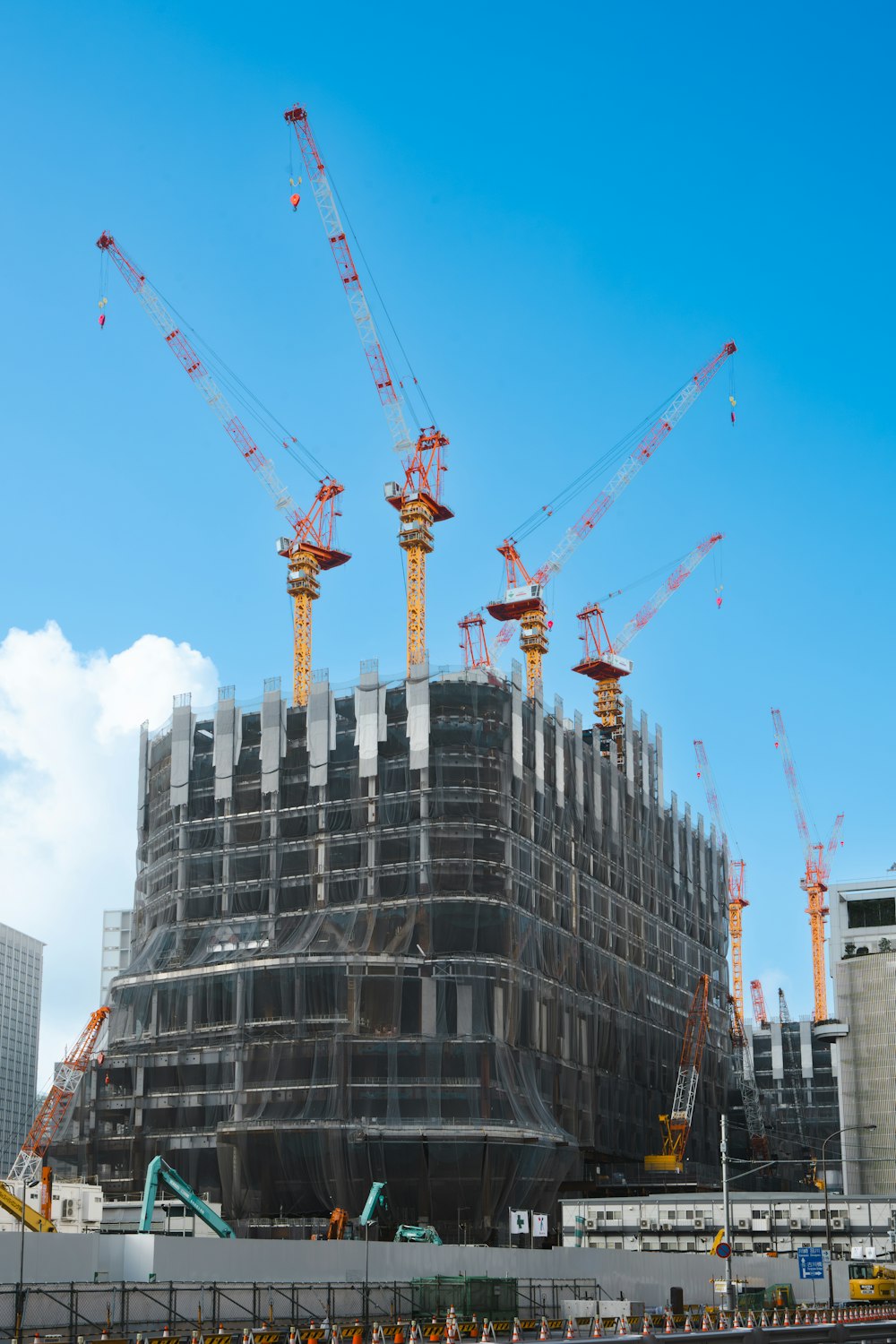 a large building under construction with lots of cranes
