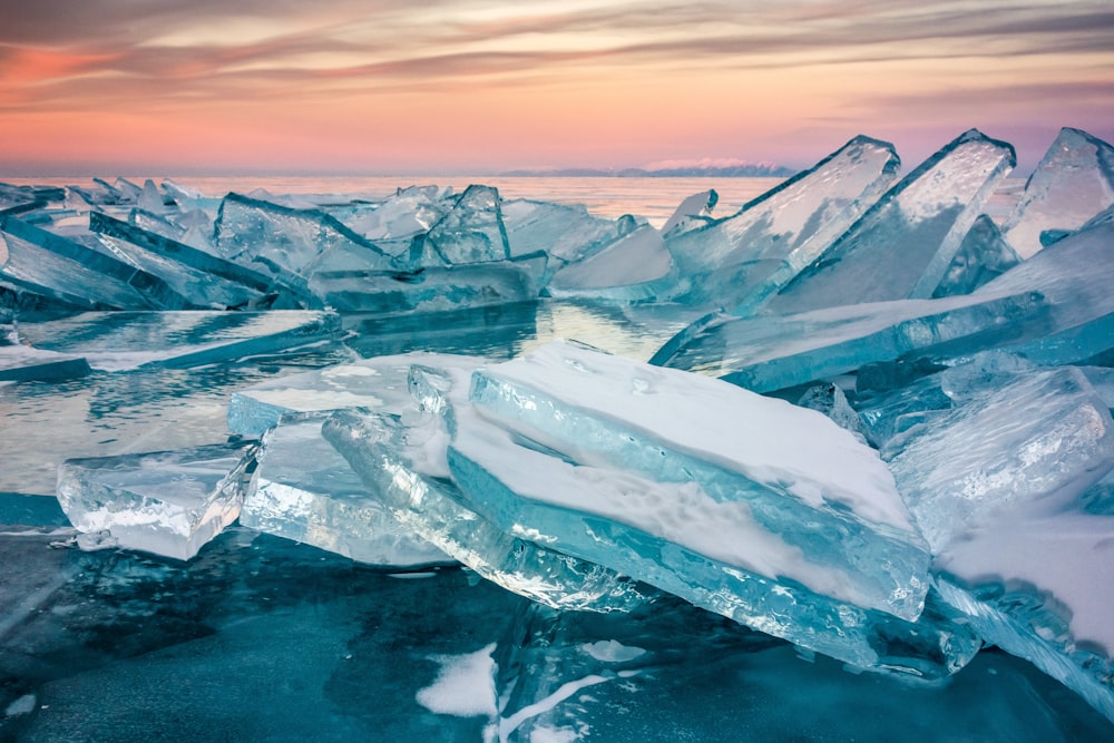 a large group of icebergs floating on top of a body of water