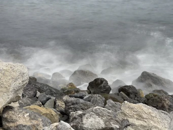 a bunch of rocks that are by the water