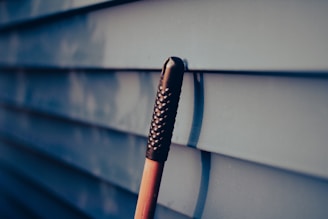 a close up of an umbrella on the side of a building