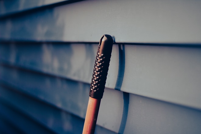 a close up of an umbrella on the side of a building