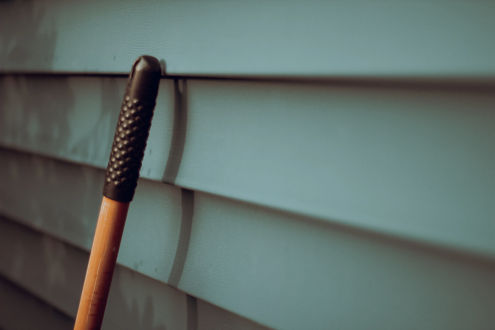 a close up of an umbrella on the side of a building