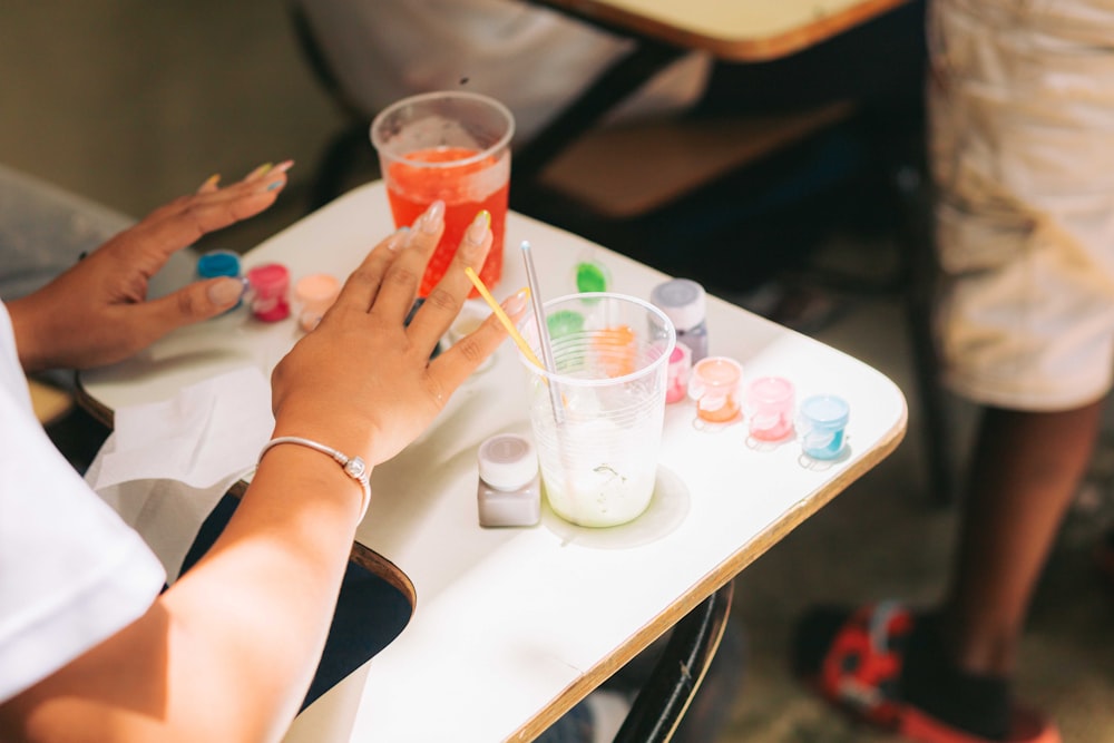 a person sitting at a table with a drink