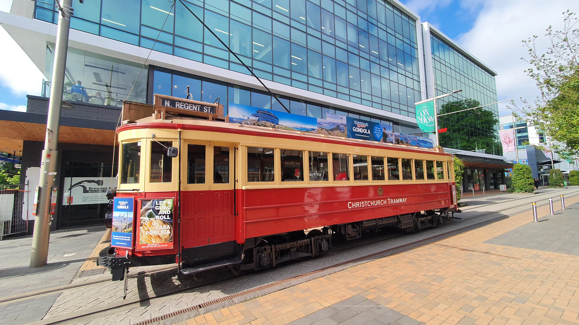 a red and yellow trolley on a city street