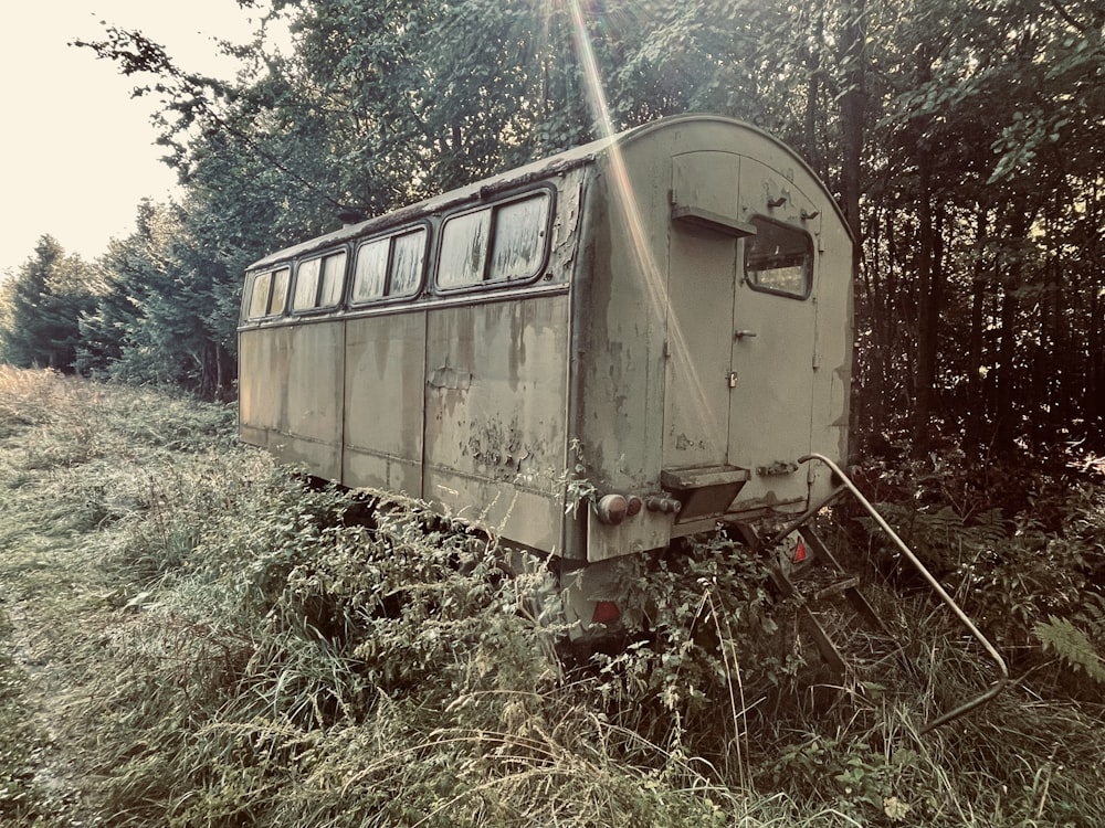 an old train car sitting in the middle of a field