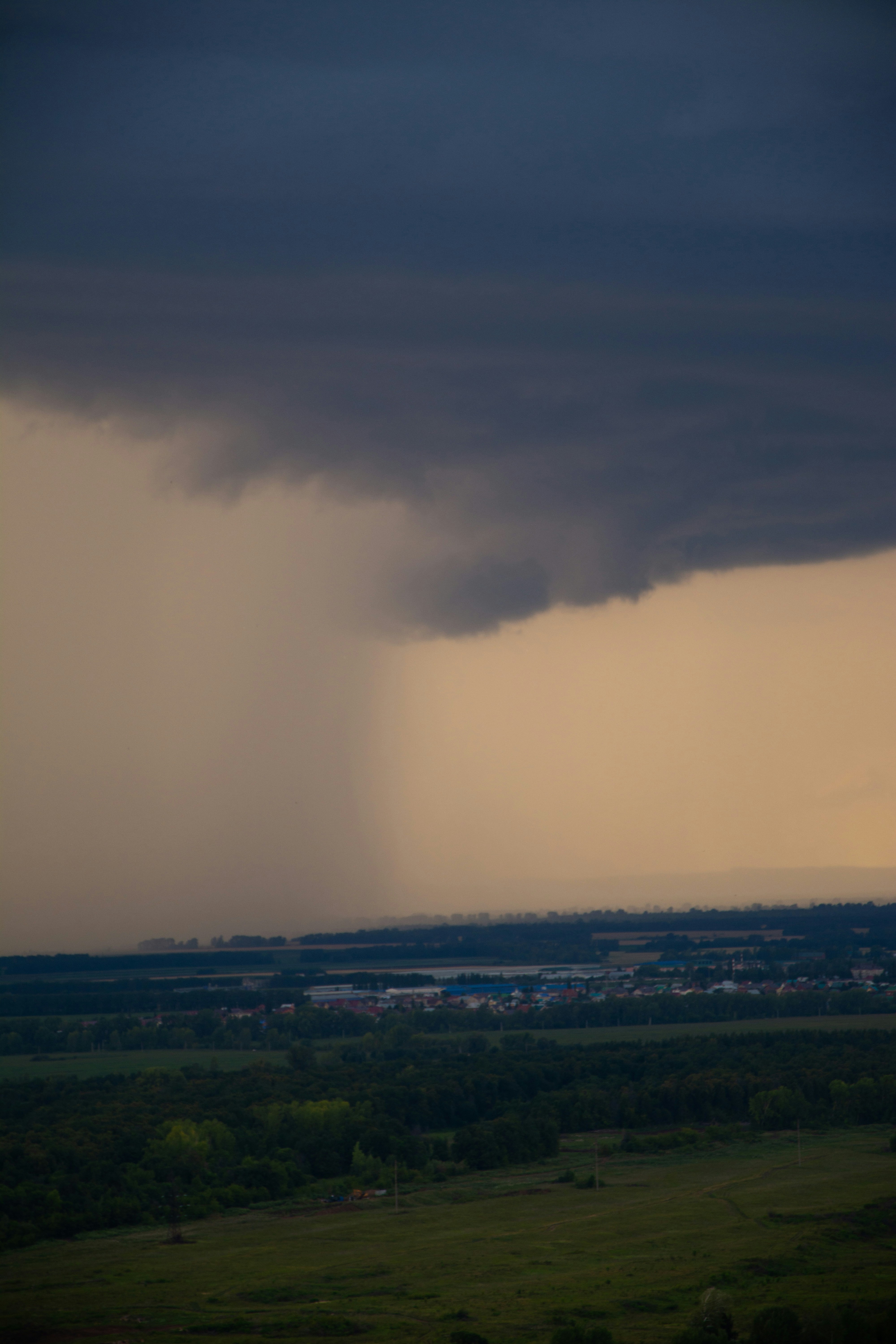 a large storm moving across the sky over a field