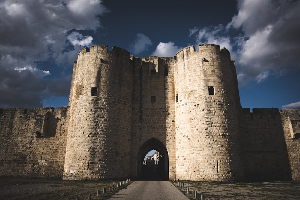 a large stone castle with a walkway leading to it