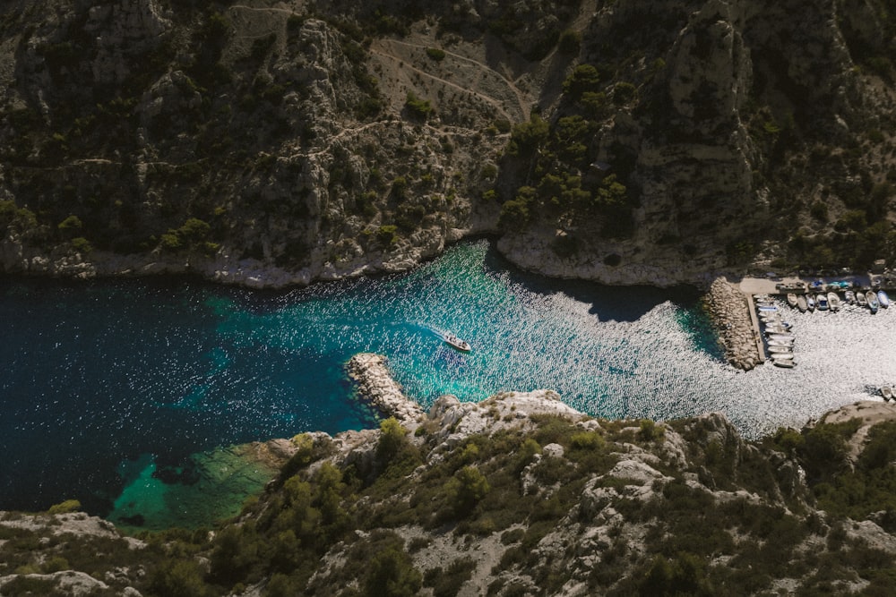 an aerial view of a body of water surrounded by mountains