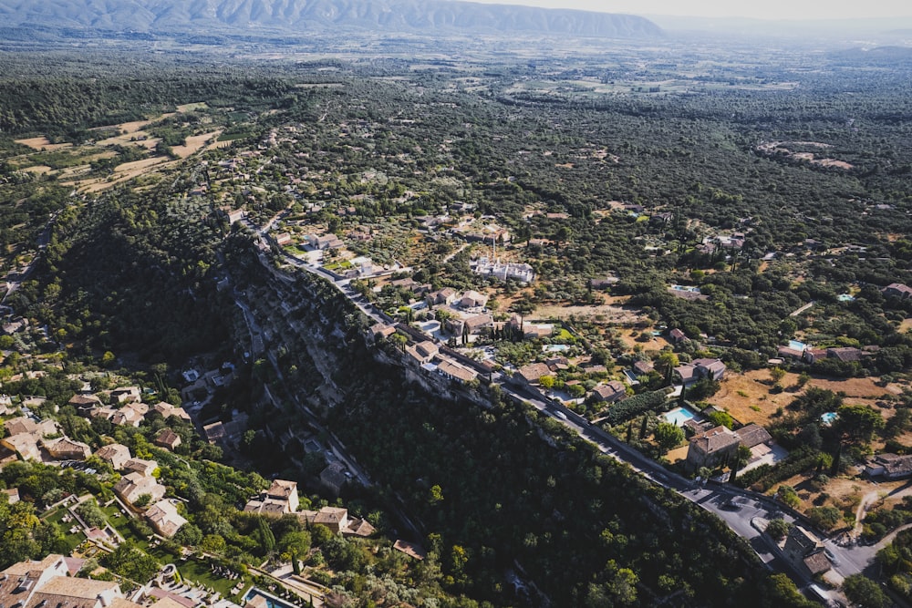 an aerial view of a city with a mountain in the background