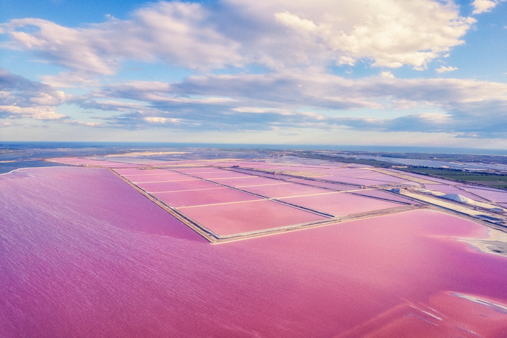 an aerial view of a large pink lake