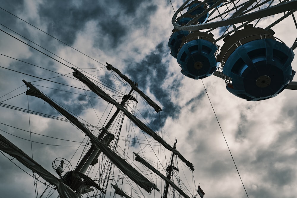 a ferris wheel and some power lines against a cloudy sky