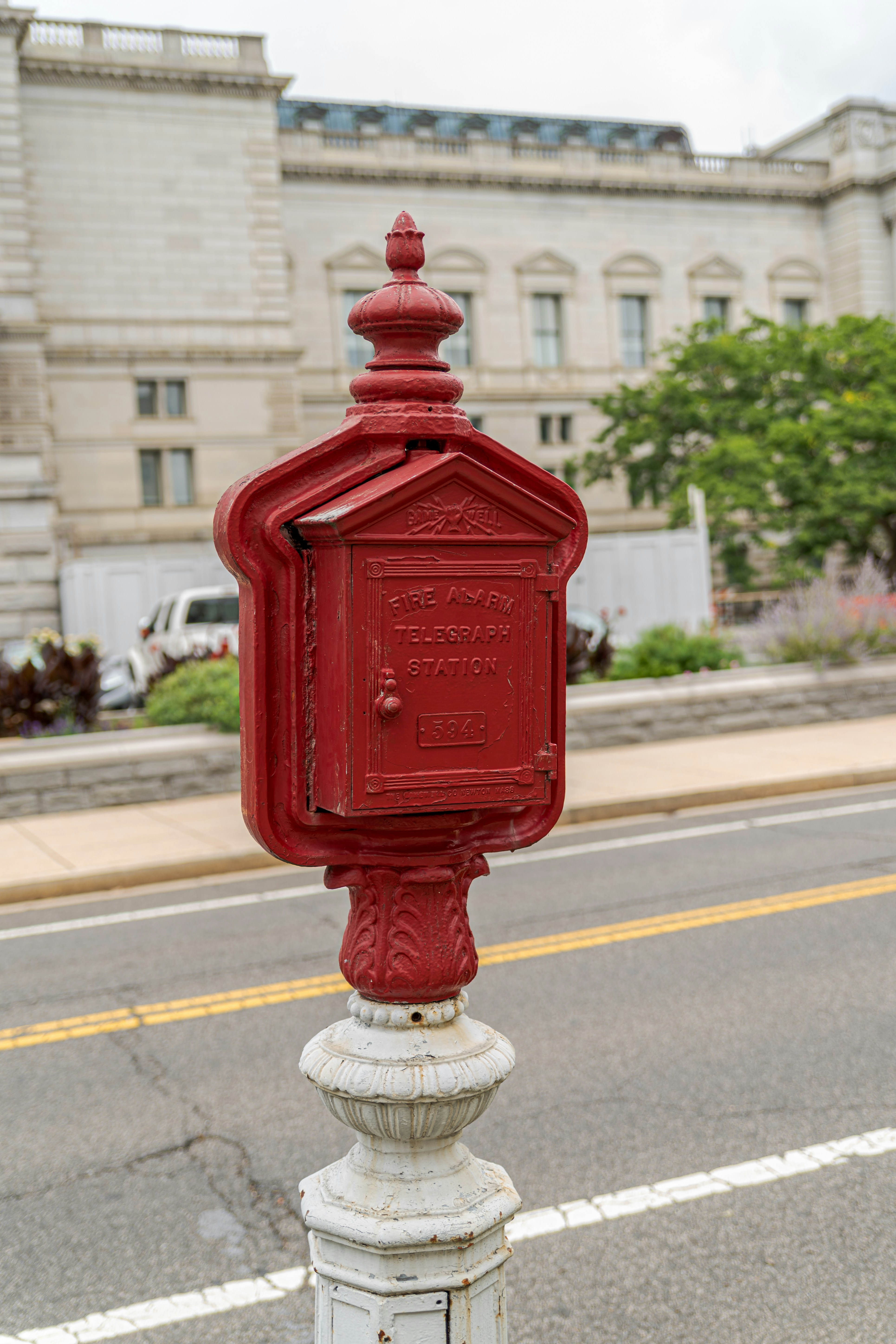 a red mailbox sitting on the side of a road