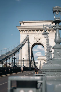 a man riding a bike across a bridge