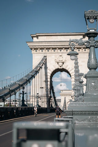 a man riding a bike across a bridge