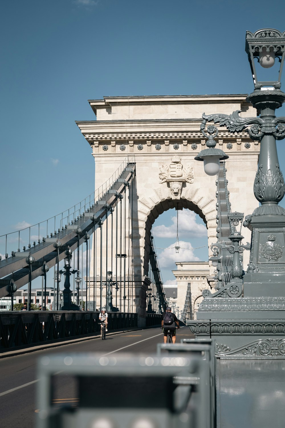 a man riding a bike across a bridge