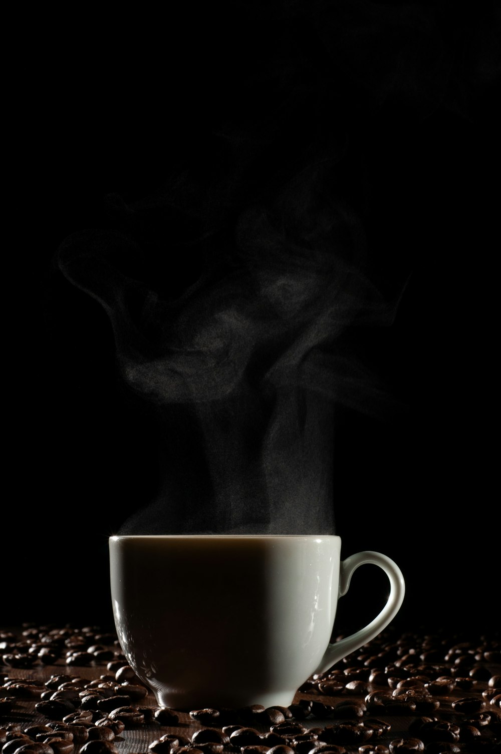 a cup of coffee with steam rising out of it