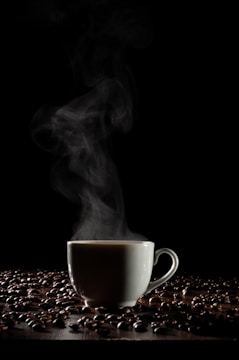 A steaming cup of coffee surrounded by nature.
