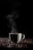 A cozy kitchen scene with a steaming cup of coffee beside a Vayo coffee box.