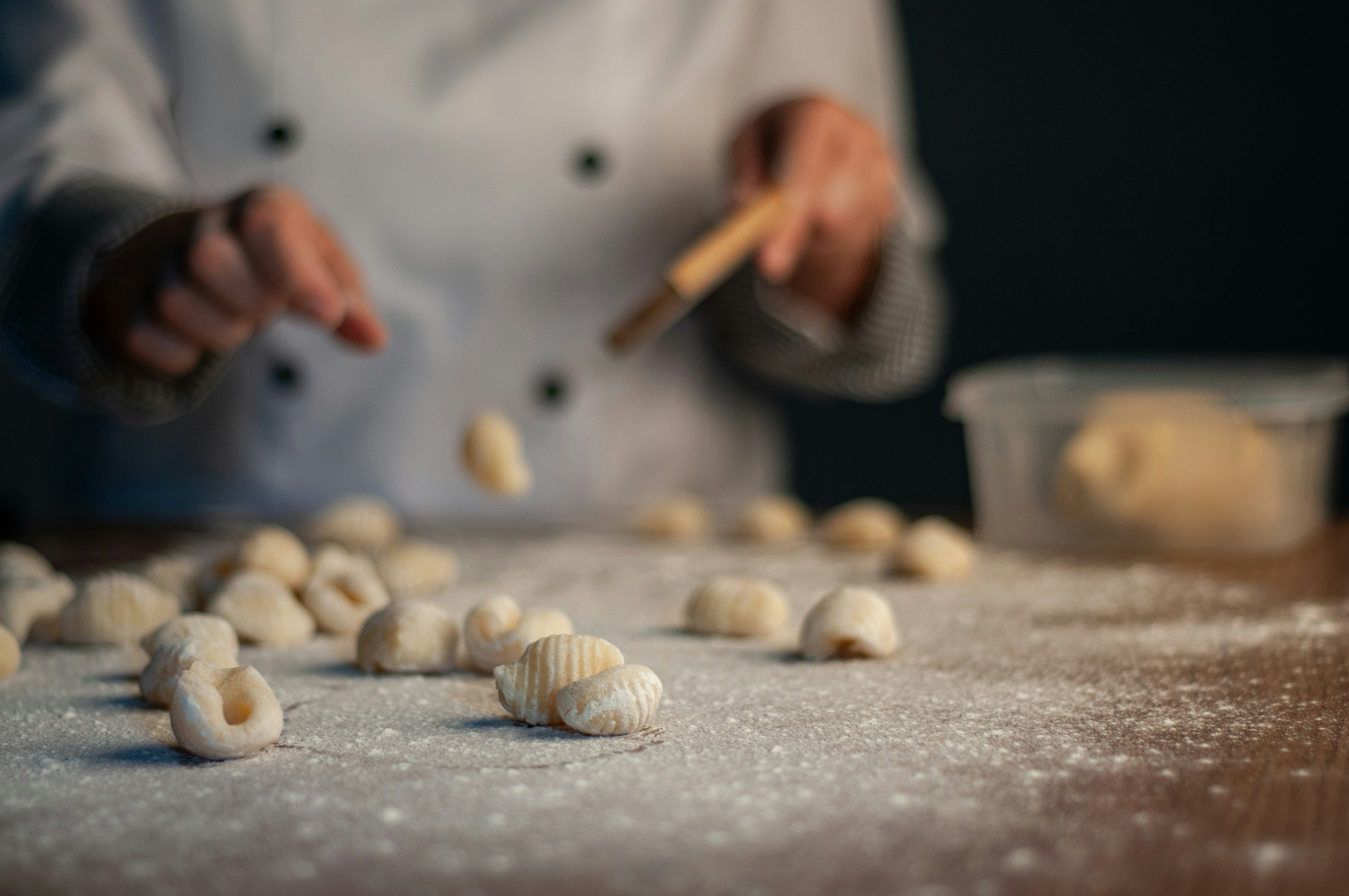 a person in a chef's coat is making food