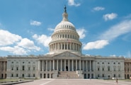 a large white building with a flag on top of it