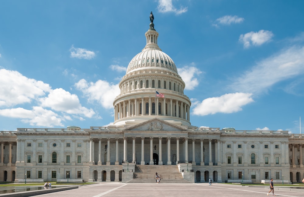 a large white building with a flag on top of it