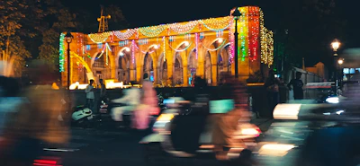 A vibrant LED curtain illuminating the exterior of a busy storefront at night.