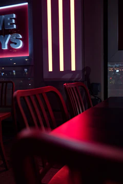 A stylish party scene featuring red accents, sleek tables, and ambient lighting in an industrial zone setting.