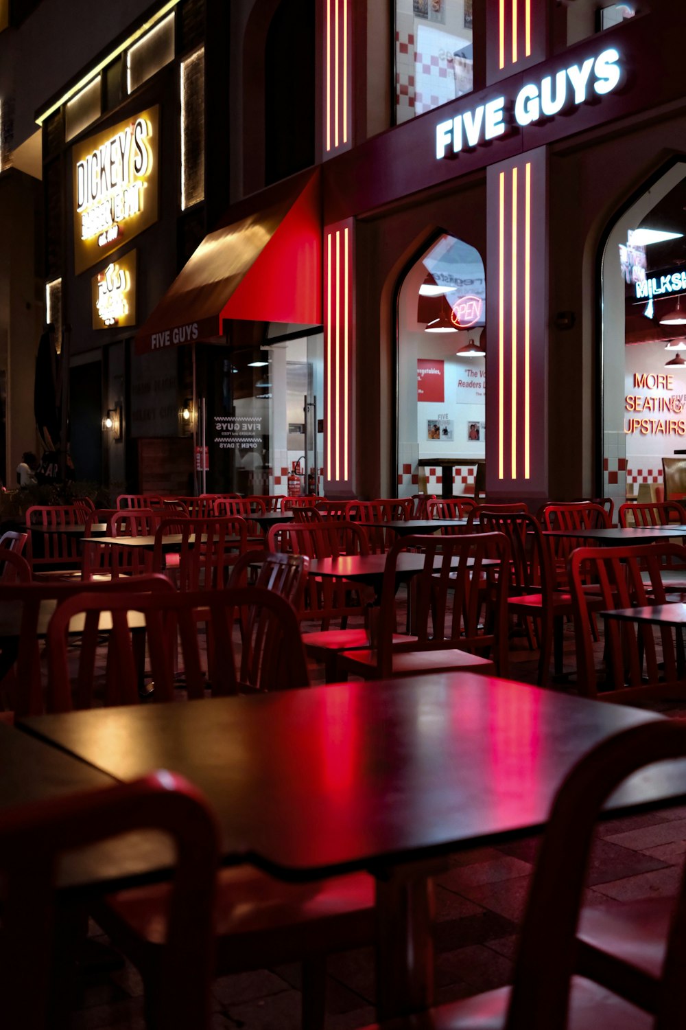 a restaurant with tables and chairs in front of it