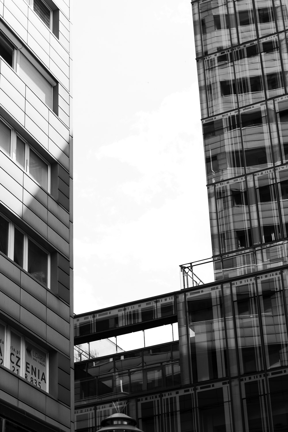 a black and white photo of a building and a train