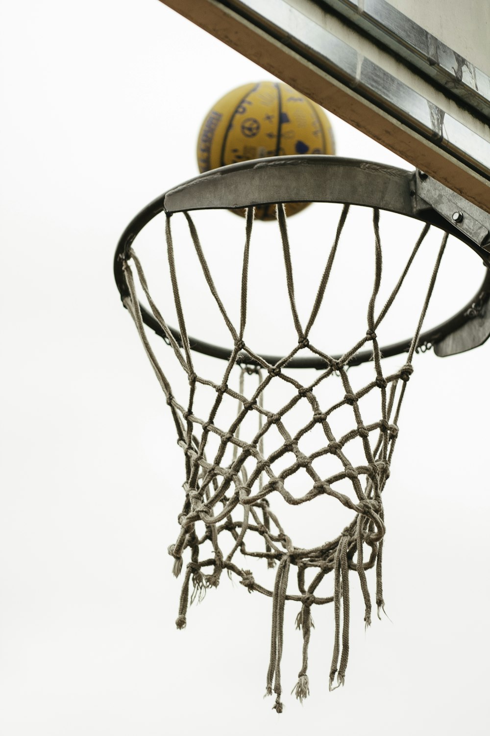 a basketball going through the net of a basketball hoop