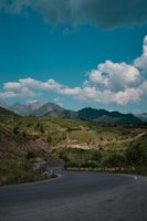 A winding highway through lush green hills in Europe.