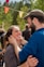 A joyful wedding celebration scene with friends laughing and dancing together in a festive atmosphere.