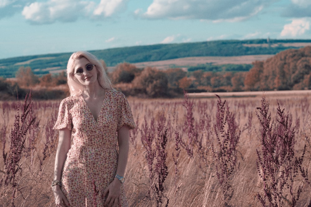 a woman standing in a field of tall grass