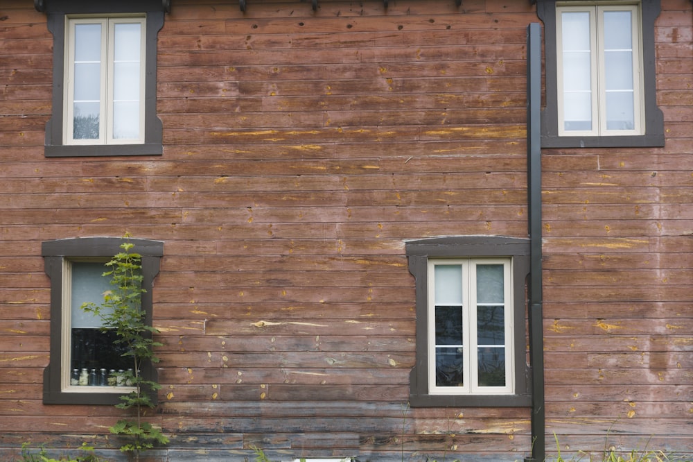 a building with two windows and a bench in front of it