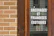 A sparkling clean storefront window reflecting a sunny street in Gaillon.