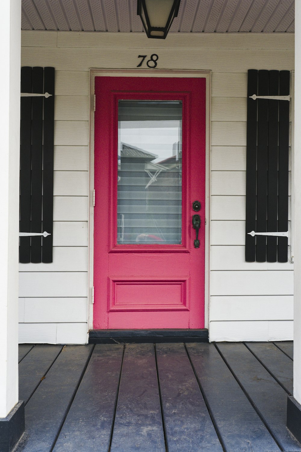 a red front door on a white house