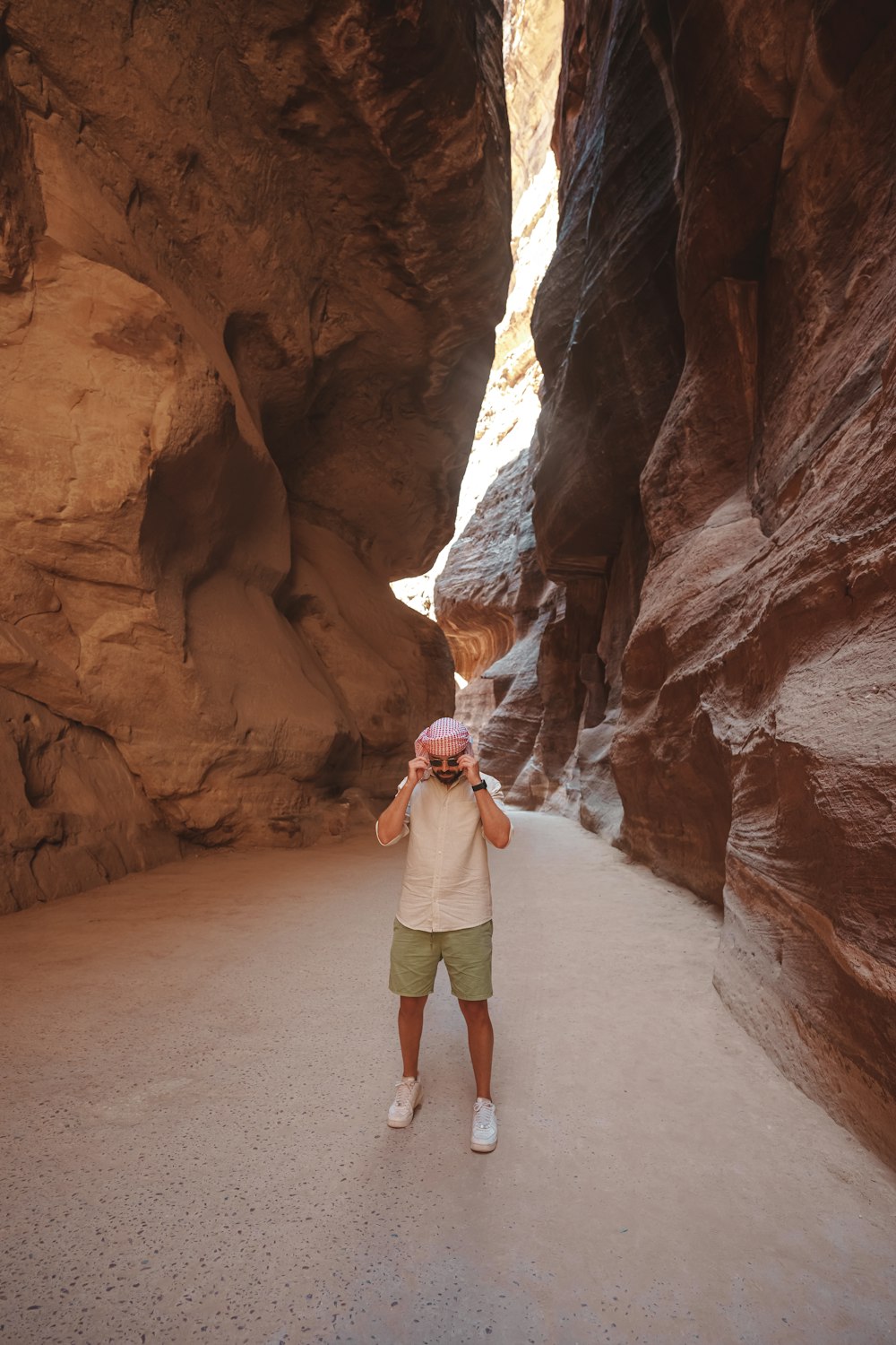 a person standing in a narrow slot in a canyon