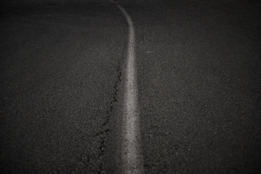 a black and white photo of a straight road