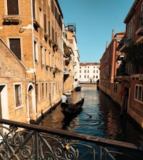 A warm photo of the ia venezia team collaborating in a cozy Venetian office, with views of canals in the background.