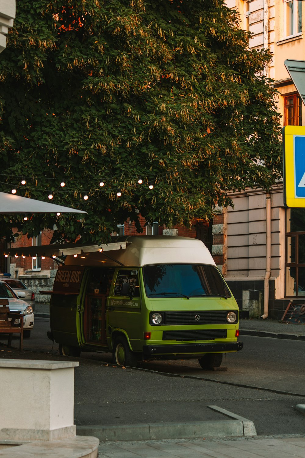 a green van parked on the side of the road