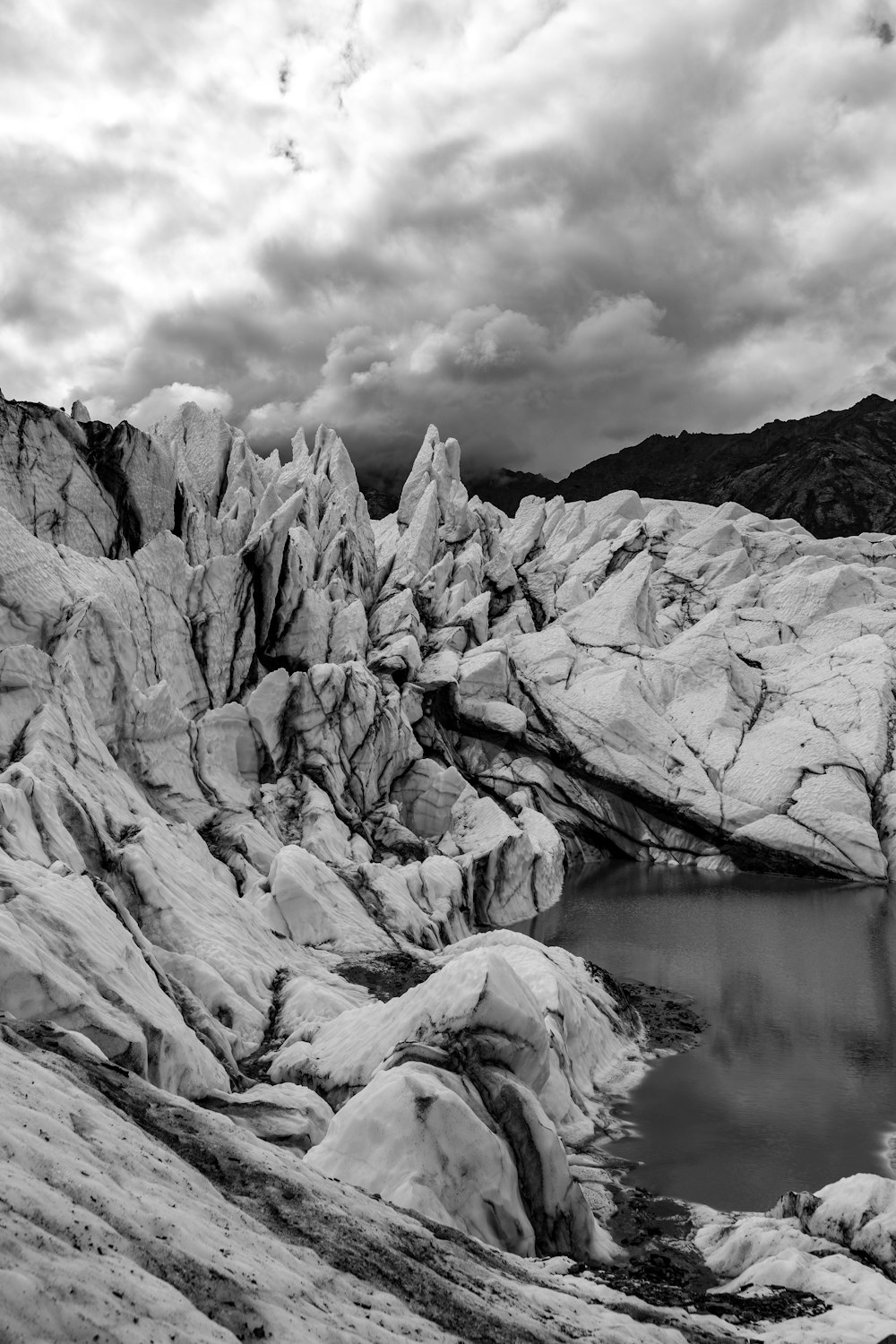 a black and white photo of a mountain lake