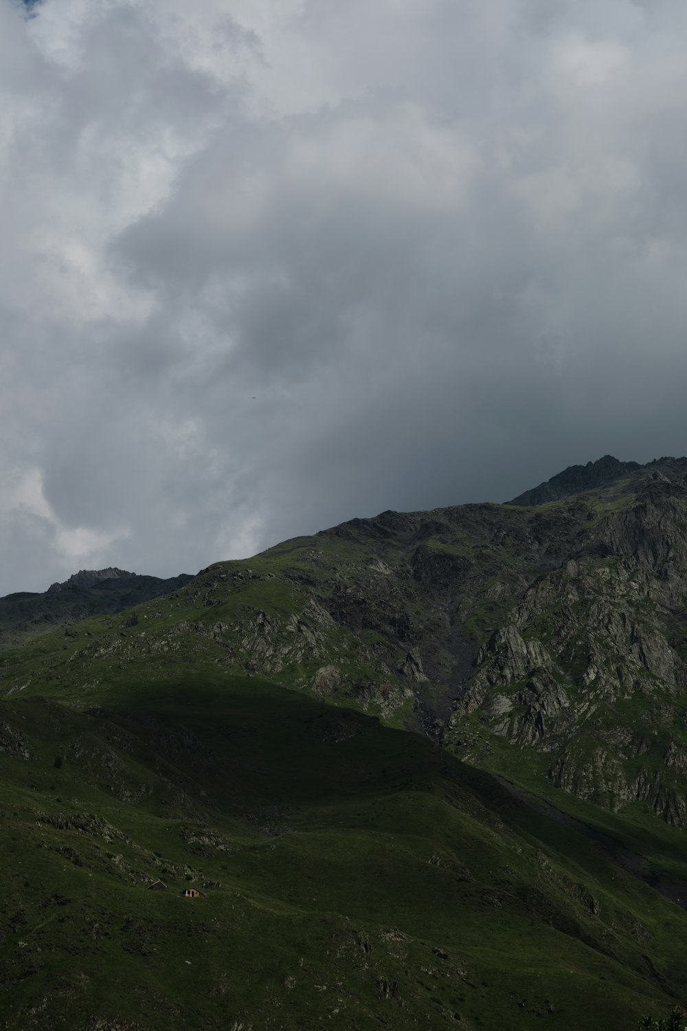 a mountain with a few clouds in the sky