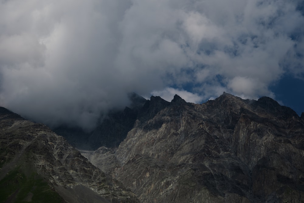 a mountain range with a few clouds in the sky