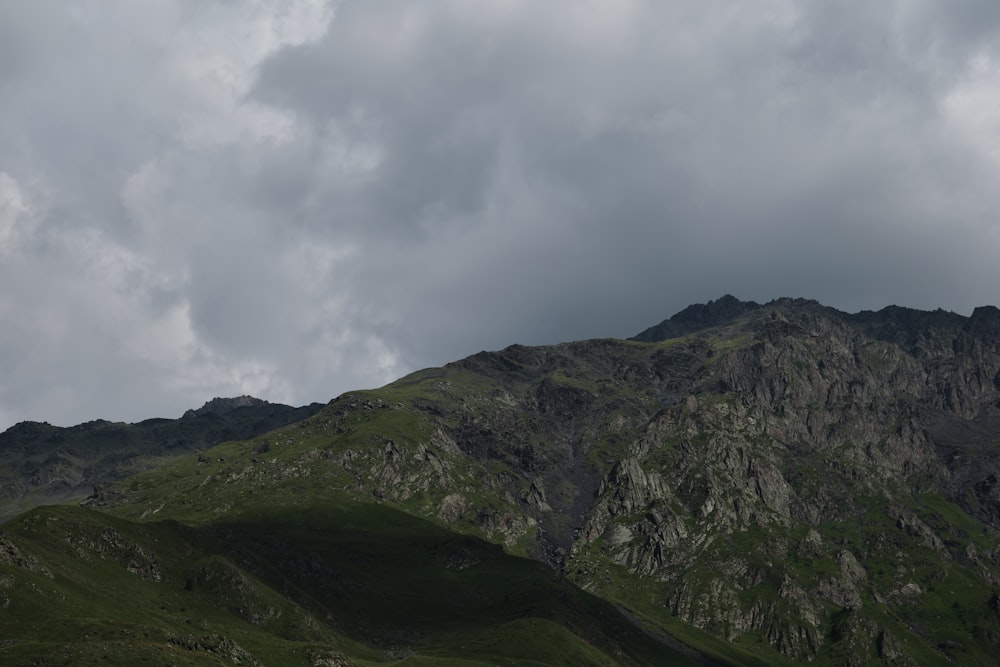 a mountain with a cloudy sky in the background