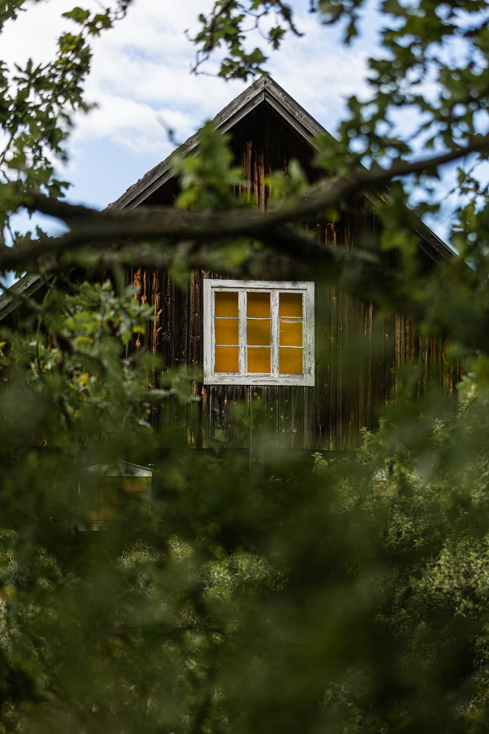 a window in the side of a wooden building