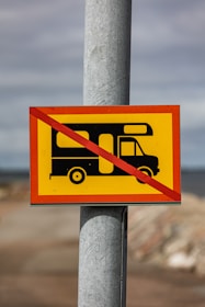 a yellow and red sign that is on a pole