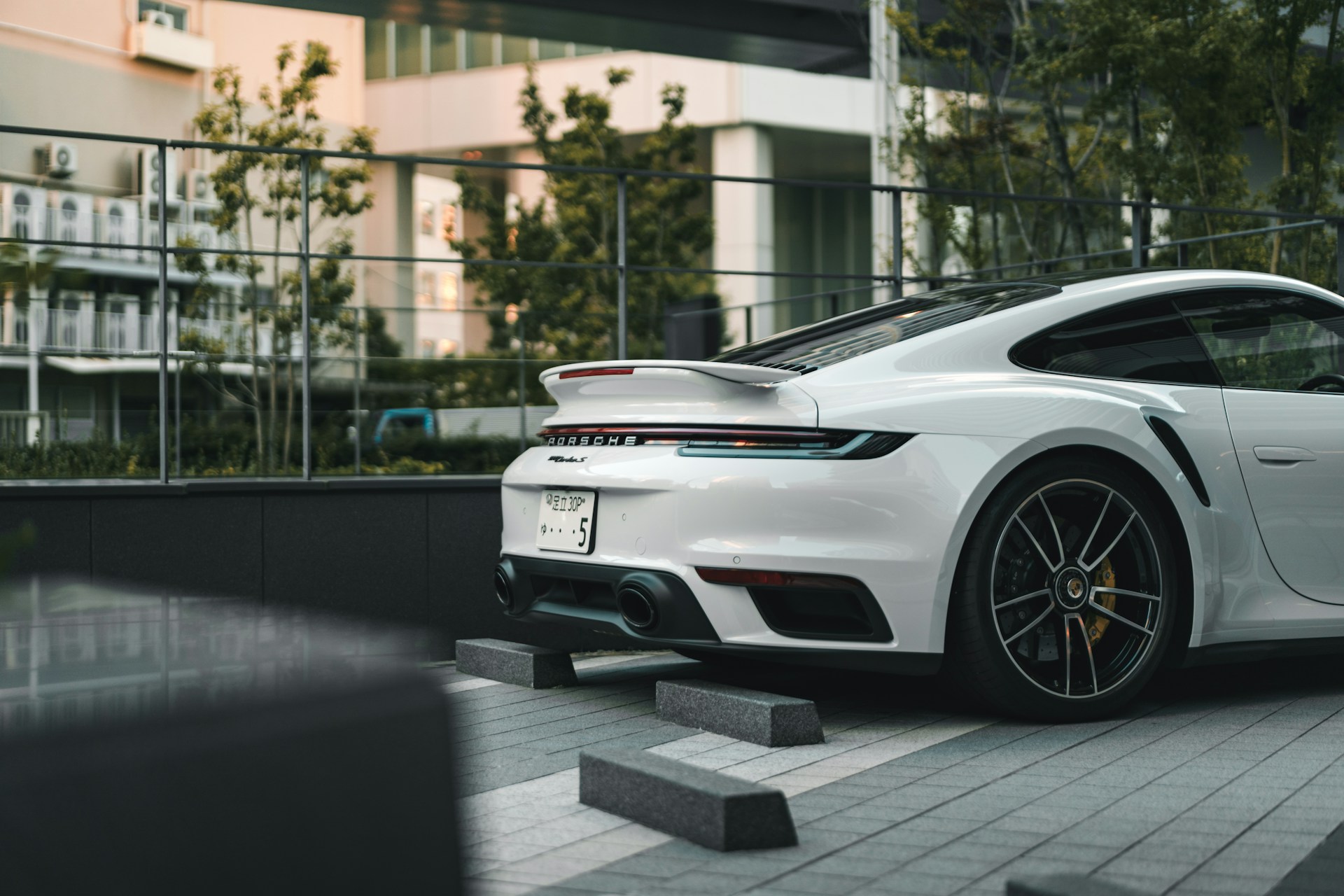 a white sports car parked in front of a building